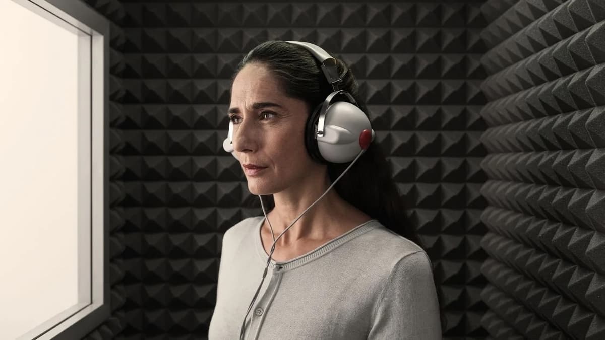 Patient undergoing hearing test in sound booth